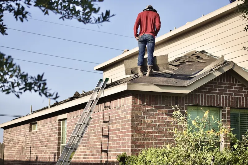 Professional roofer working on a residential roof in Roeland Park